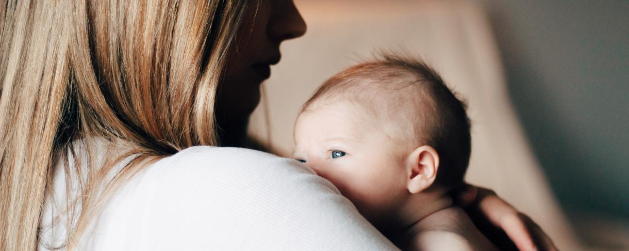 Side view of mum holding baby