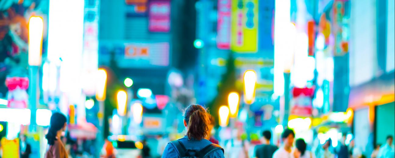 Person in city with bright colourful lights 