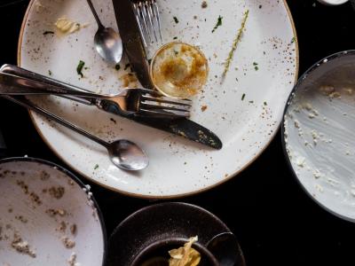 Empty dirty plates and cutlery